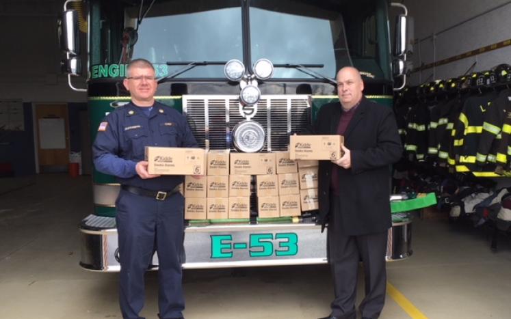 Fire Chief James Alexander and Fire Marshal Charles DeFrangesco with the allotment of smoke detectors.